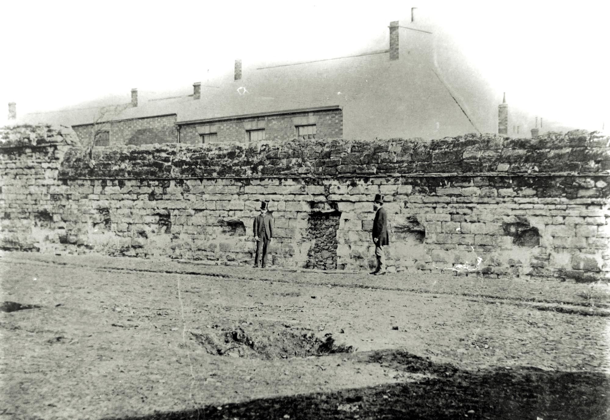 South wall of the Newarke in Mill Lane, viewed from inside the Newarke, 1870s.  Gun ports and a blocked doorway can be clearly seen -