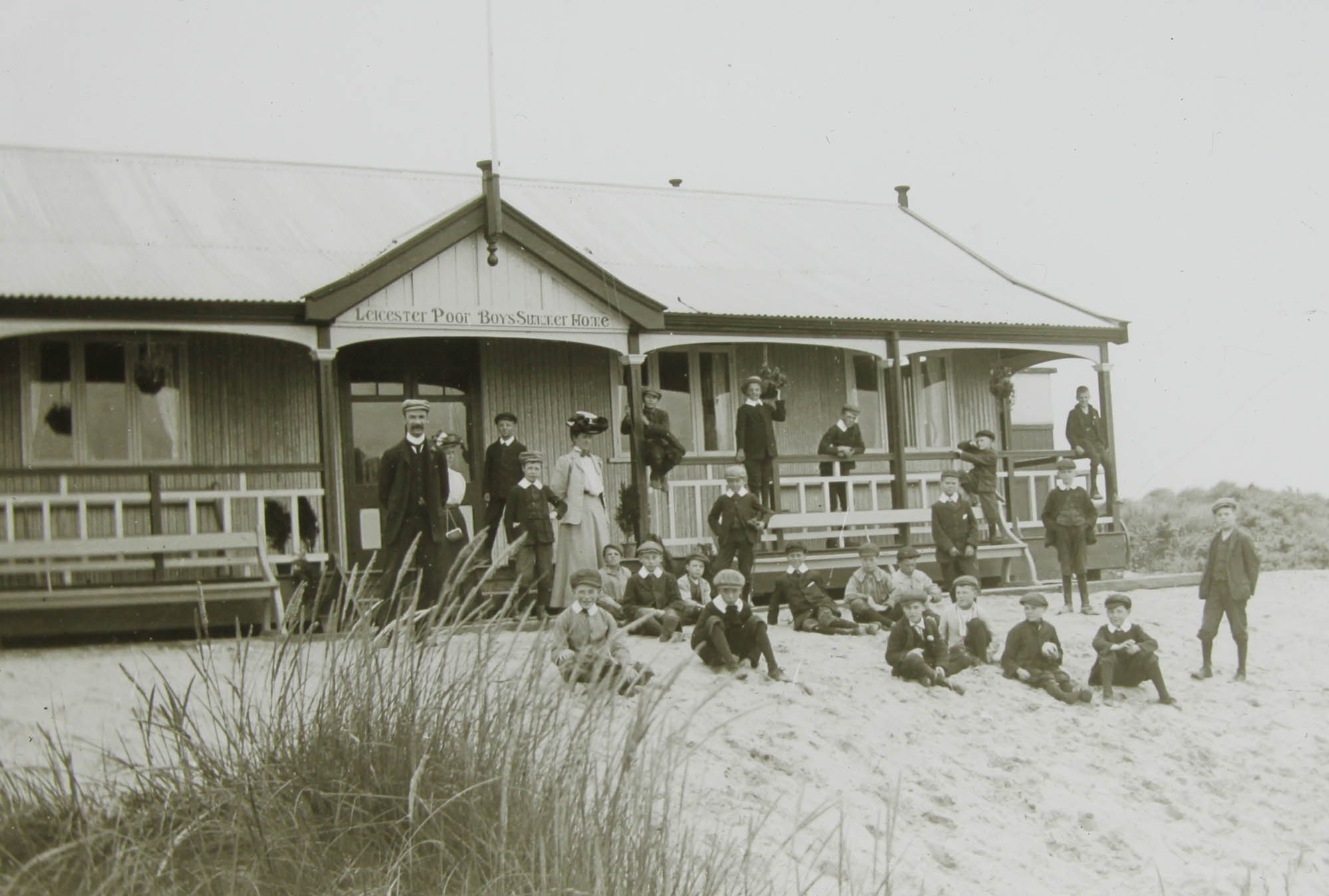 A group outside the wooden chalet -